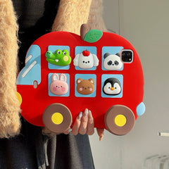 Close-up front view of the 3D cartoon animal iPad cover being held up, showing the thick protective red silicone frame and detailed animal figures.