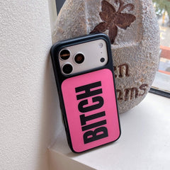 An edgy hot pink graphic phone case leaning against a decorative stone outdoors.