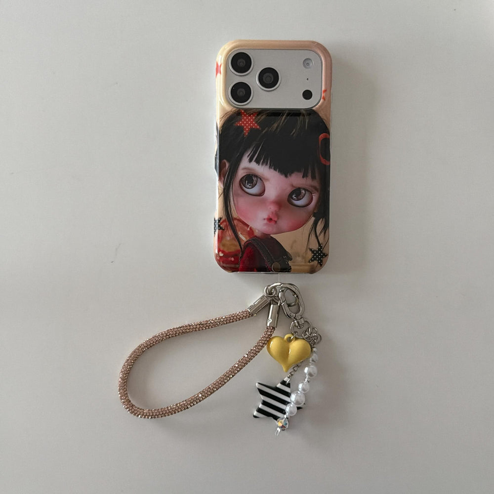 Black-haired big-eye doll iPhone case with heart and star charm wrist strap.