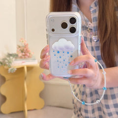A clear cloud and star pattern iPhone case with an attached blue and clear crystal beaded wristlet lanyard.