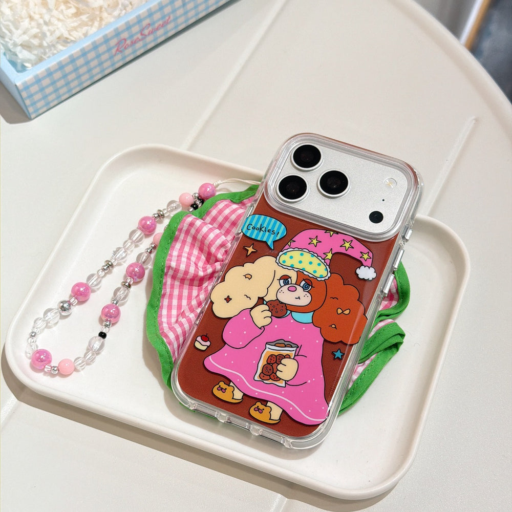 A clear kawaii dog phone case with a pink beaded lanyard resting on a white tray with a checkered cloth.