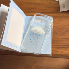 A mirror selfie showing a clear 3D cloud star iPhone case with the crystal beaded strap looped on the wrist.