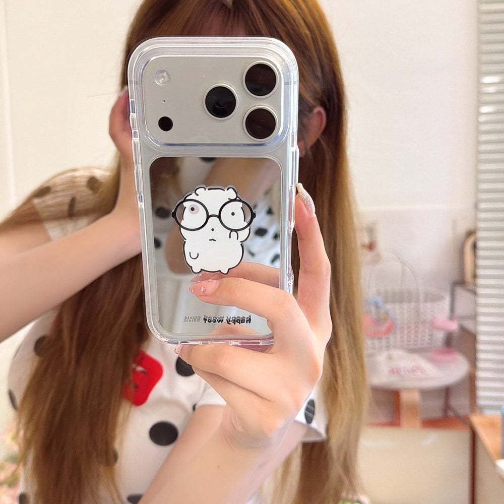 Mirror selfie showing a girl holding a cute cartoon hamster mirror iPhone case with a silver camera frame.