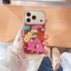 Top view of a person holding a cute cartoon puppy iPhone case with a pastel beaded bracelet charm.