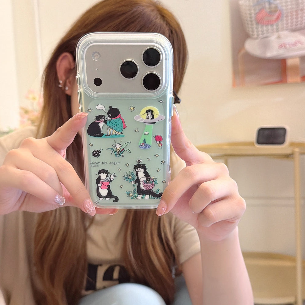 Girl holding a mint green mirror iPhone case featuring cute black cat and bear illustrations for a trendy Y2K look.