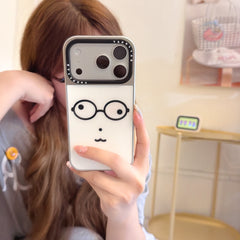 Mirror selfie showing a cute geek face phone cover with a silver camera frame.