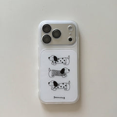A flat lay view of a clear aesthetic iPhone case featuring three cute cartoon dachshund dogs on a white background.