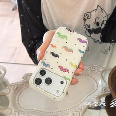 A hand tilting a cute mustache iPhone case over a white decorative tray.