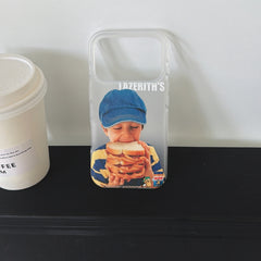 An empty funny retro sandwich boy iPhone case standing on a black shelf next to a coffee cup.