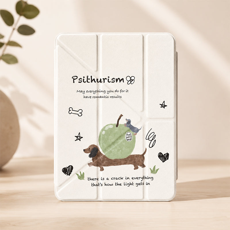 A professional product studio shot of a funny sausage dog ipad cover standing vertically on a light wooden tabletop, with soft warm lighting and a blurred green plant in the background.