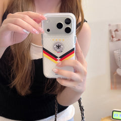 A girl taking a mirror selfie holding a silver Germany football themed mirror phone case.