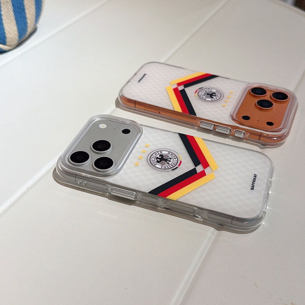 Two Germany football mirror iPhone cases in silver and gold colors placed flat on a table.