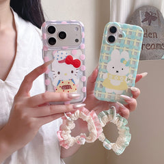 A person holding both the pink polka dot kitty case and the blue plaid bunny case showing the fabric scrunchie straps.