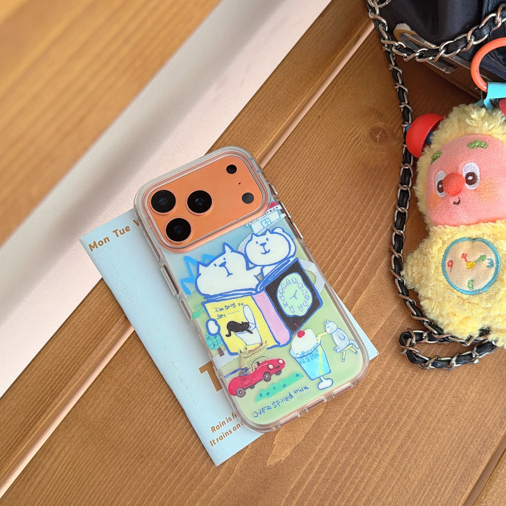 An aesthetic clear phone case with a whimsical cat doodle pattern resting on a book next to a yellow plush toy.