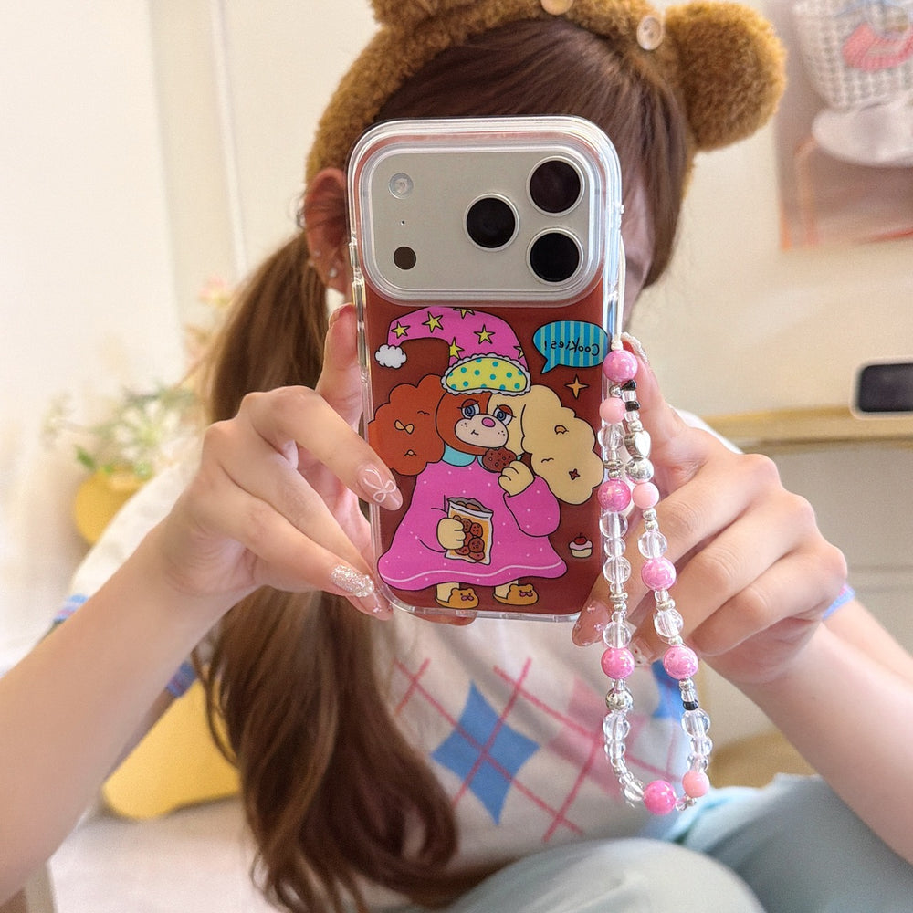 A girl taking a mirror selfie holding a kawaii cartoon dog iPhone case with a silver camera frame and pink beaded strap.