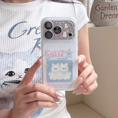 A girl holding a clear shockproof phone case with kawaii white puppy prints over a casual graphic tee.