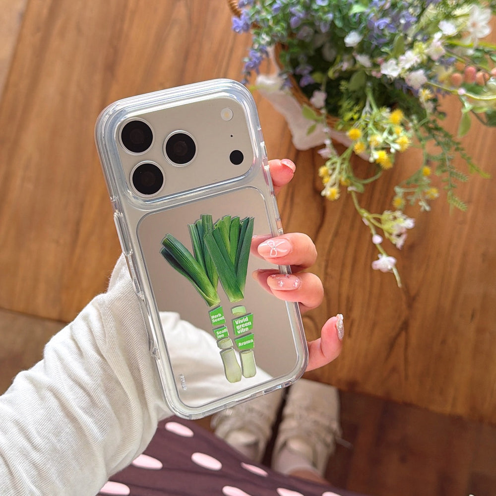 Hand holding a Korean style green leek mirror phone shell with a protective silver camera ring option.