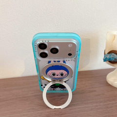 A cute Labubu soccer iPhone case standing vertically on a wooden table using its silver metal ring kickstand.