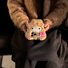 Close-up of a leopard kitty plush iPhone case held on a lap in sunlight