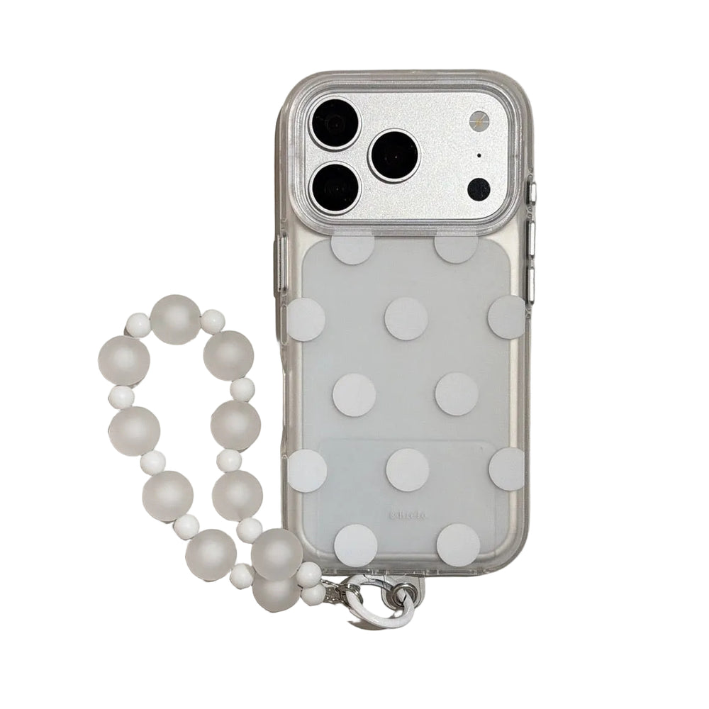 Studio view of a minimalist white polka dot transparent iPhone case featuring a frosted white beaded hand charm.