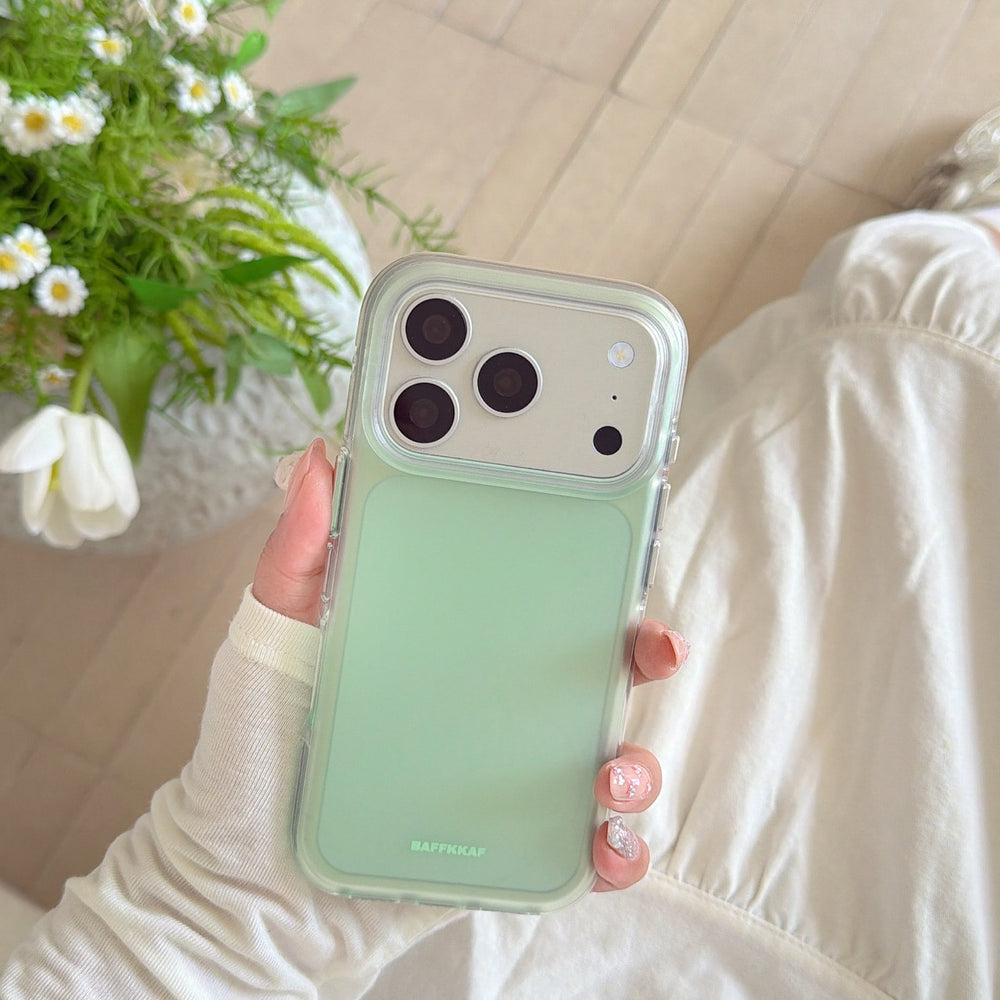A hand displaying a mint green cute phone cover next to a beautiful bouquet of white daisy flowers.