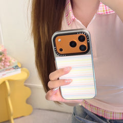 Hand holding the pastel stripe iPhone case variant with a metallic orange gold camera frame.