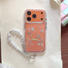 Orange iPhone in clear case with silver floral vine pattern and pearl strap