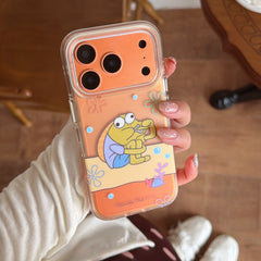 A hand holding an orange cartoon fish iPhone case showcasing its metallic orange camera protection frame.