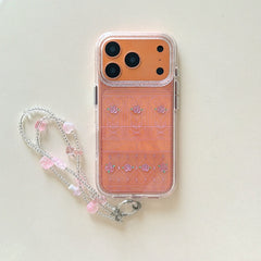 Product shot of an orange rose gate clear phone case with a matching pink beaded strap.