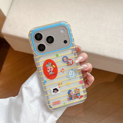 A hand holding a clear Osamu Harada striped iPhone case showing cute cartoon graphics and a blue lens protection border.