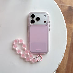 Pastel pink protective phone cover with clear edges and a matching pink frosted bead bracelet strap lying flat.