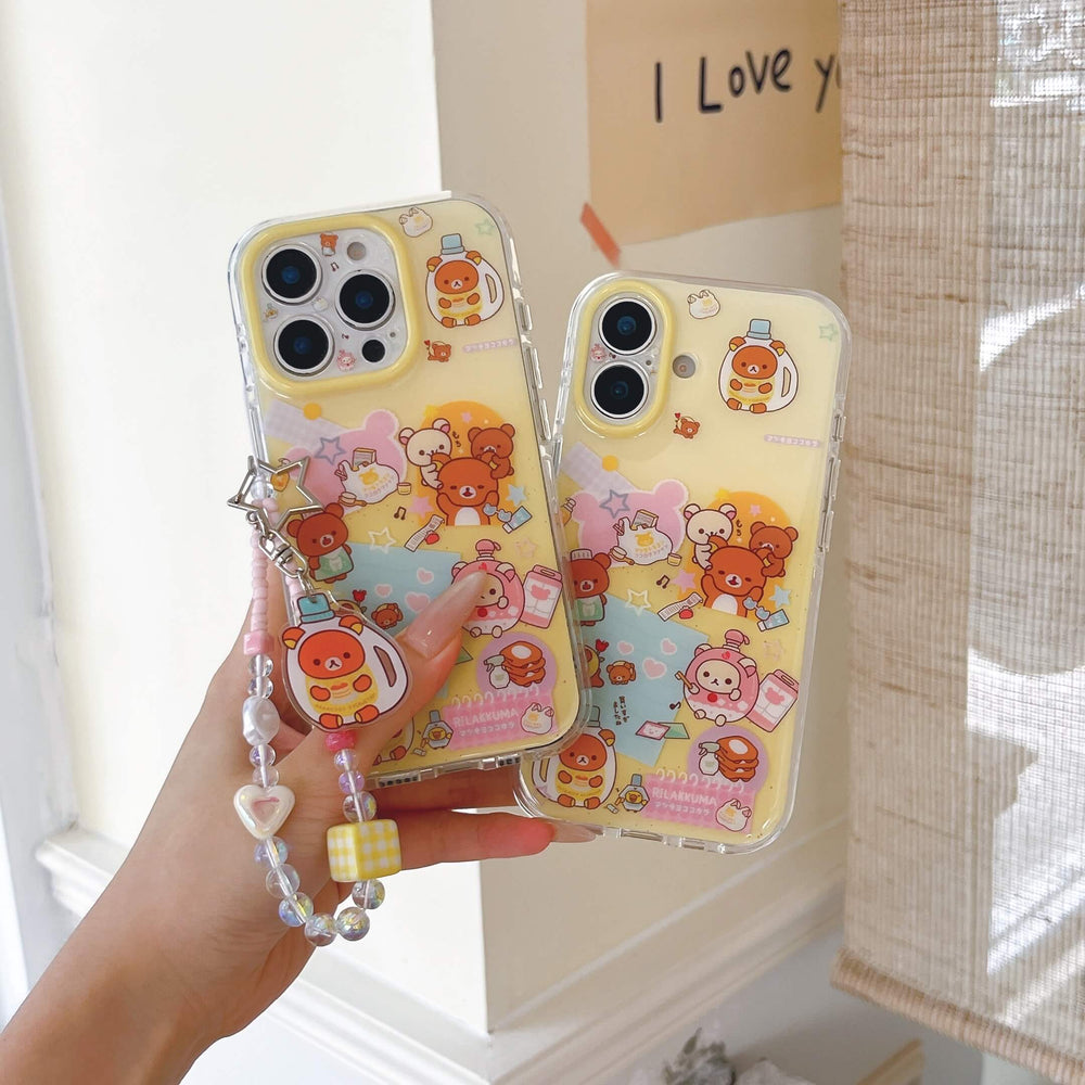 Two soft-girl aesthetic yellow cartoon bear phone cases held up against a cream wall window background.