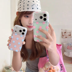Woman holding pink blue and mint pink polka dot iPhone cases