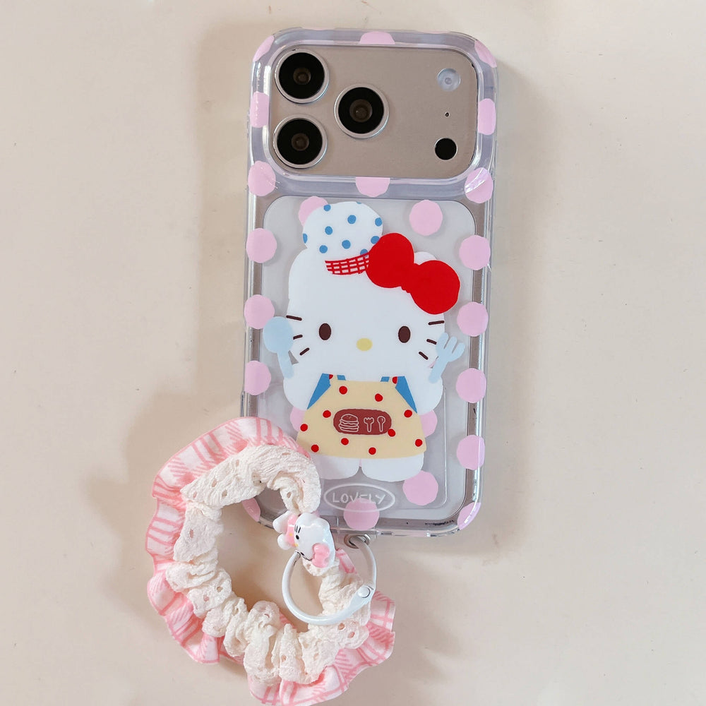 A clear pink polka dot kitty phone case flat lay on a light cream background with a pink ruffled fabric wristlet.