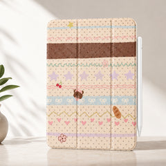 A professional studio product mockup of the cute kawaii teddy bear iPad case standing vertically on a minimalist stone surface with soft botanical shadows and a white stylus attached.