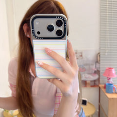 A close-up mirror selfie showing a rainbow striped aesthetic phone cover on an iPhone.