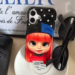 Red-haired Y2K doll iPhone case displayed beside black sunglasses.