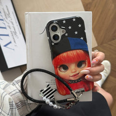 Hand holding a glossy red-haired Y2K doll iPhone case with star background.