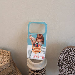 A retro girl pancake phone case displayed vertically on top of a small marble pillar stand.