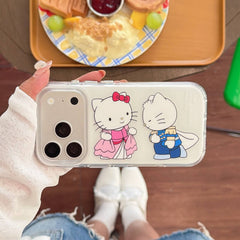 Hand holding a royal kitty couple clear iPhone case at a café table