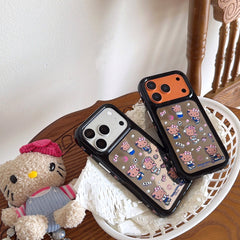Two Hello Kitty mirror phone cases with silver and orange frames displayed in a white basket next to a plush doll.