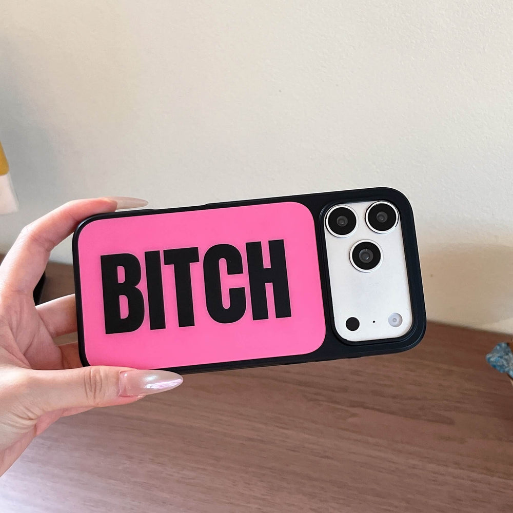 A hand holding a horizontal hot pink phone case with bold black text and a black camera bumper.