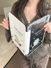 A woman holding a soft girl aesthetic tablet shell open at a V-angle, showing the connection between the clear protective back panel and the cream-colored folding front cover.