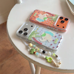 Palm elephant iPhone cases on table with lanyard