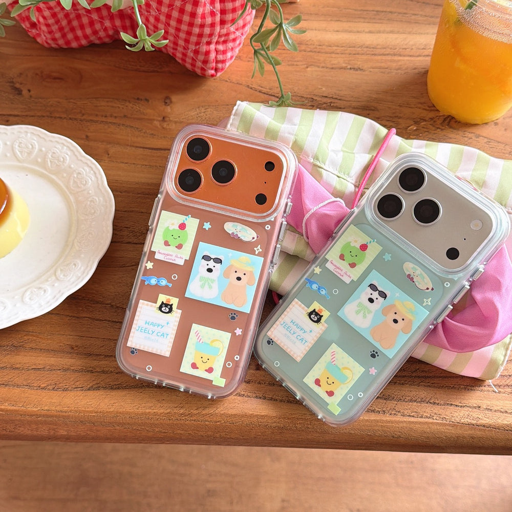 Mint green and orange sticker style iPhone covers displayed on a wooden table with a dessert plate and juice.