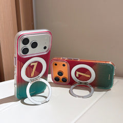 Two iphones, one white and one orange, standing on a white surface using the built-in silver magnetic ring kickstands of their matching red and teal gradient covers.