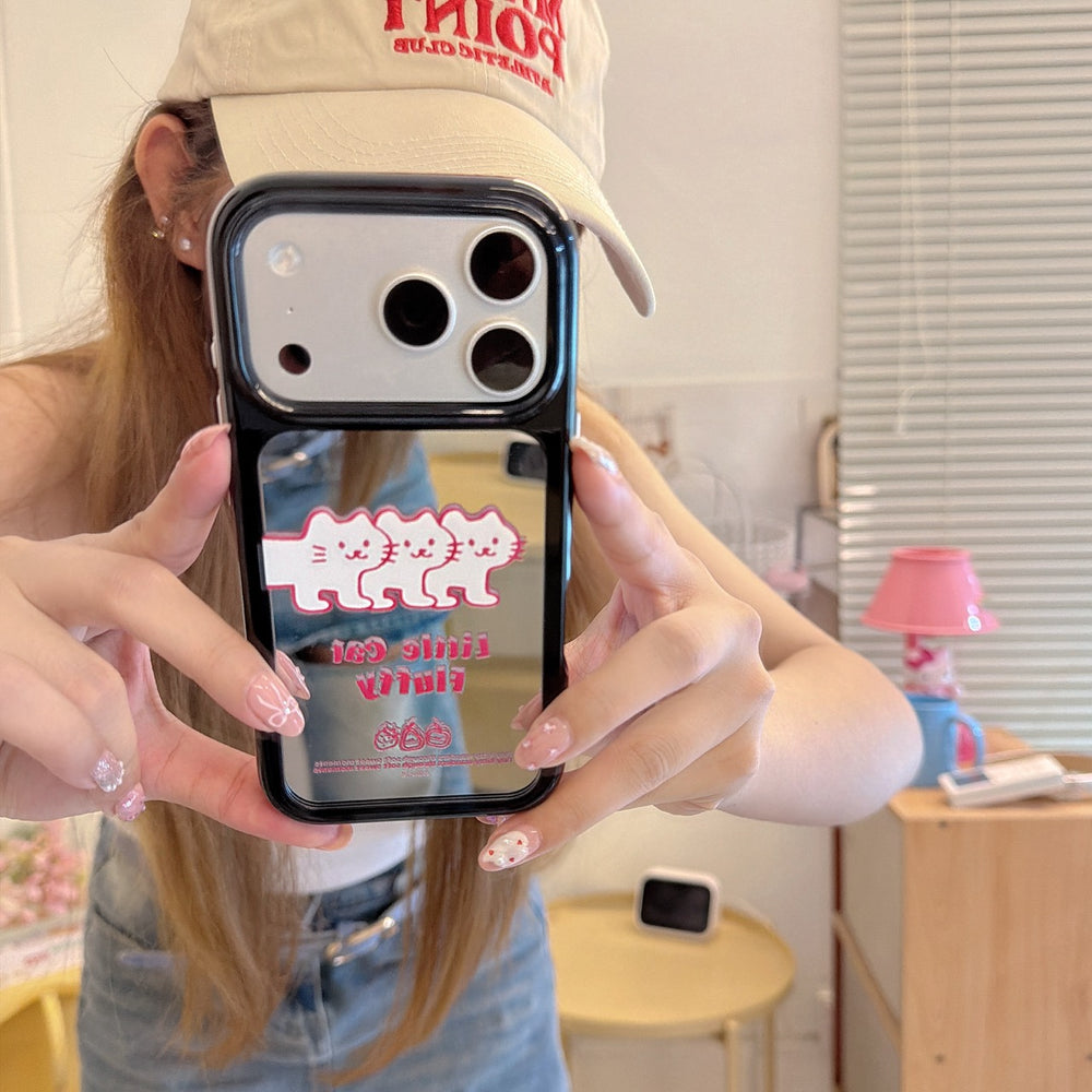 Mirror selfie showing a silver kitten mirror phone case paired with a casual streetwear outfit and cap.