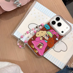 A Y2K cartoon dog phone cover with a beaded charm placed on top of an aesthetic star-patterned notebook.