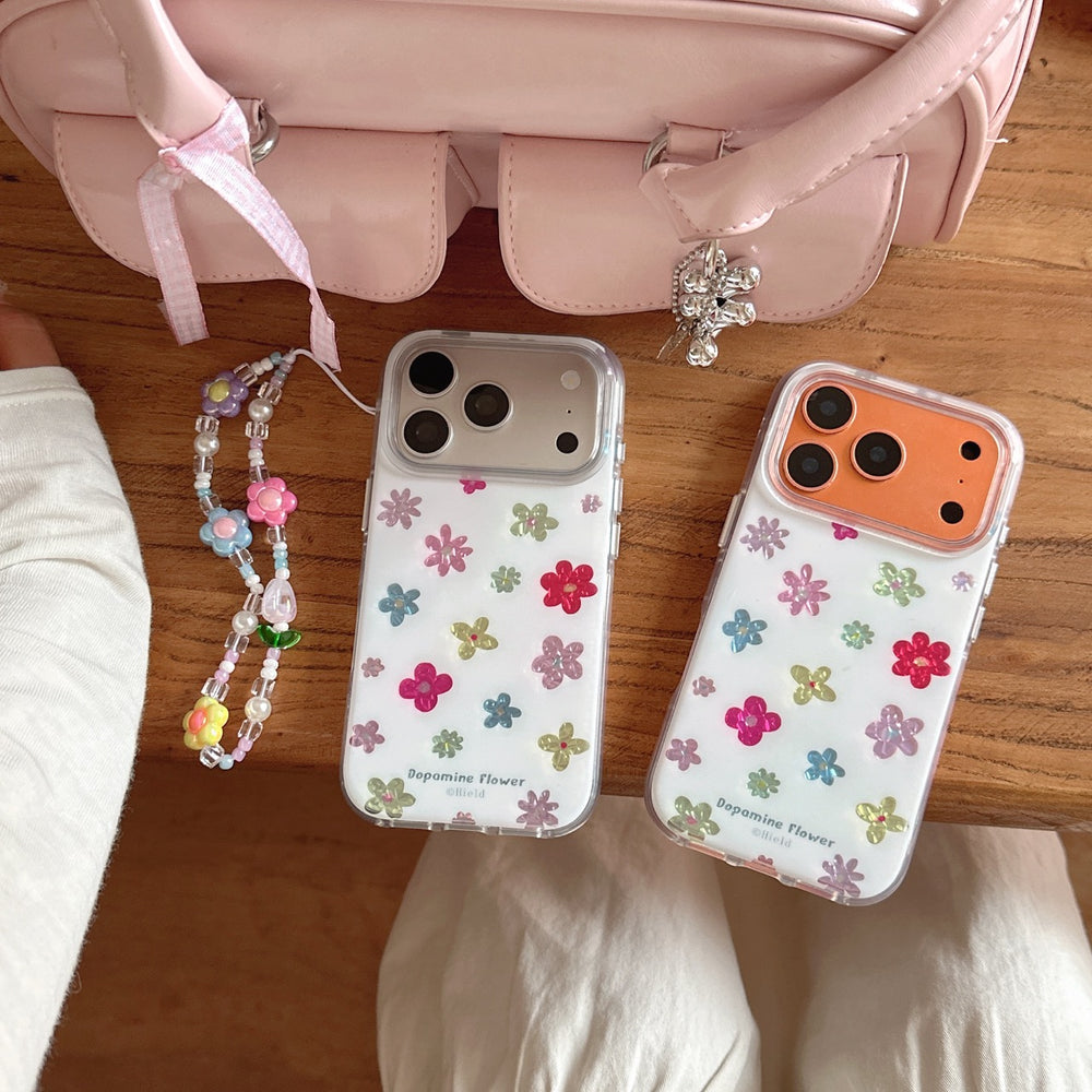 Two Y2K dopamine flower phone cases in silver and orange frames next to a pink aesthetic handbag.