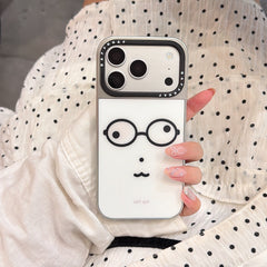 Y2K style geek glasses phone case held against a white polka dot dress background.